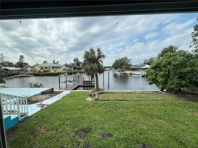 dock area featuring a yard and a water view