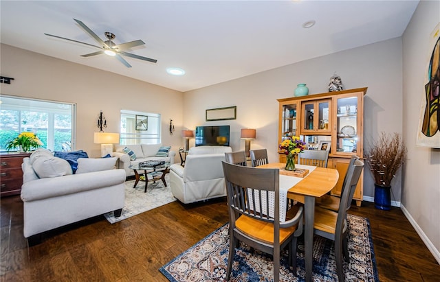 dining room with dark hardwood / wood-style flooring and ceiling fan