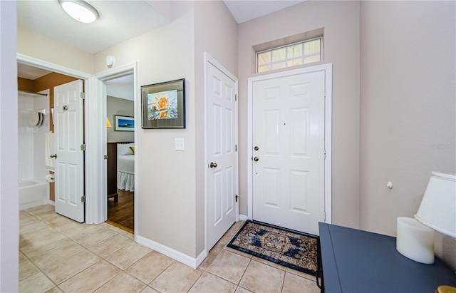 foyer entrance with light tile patterned floors