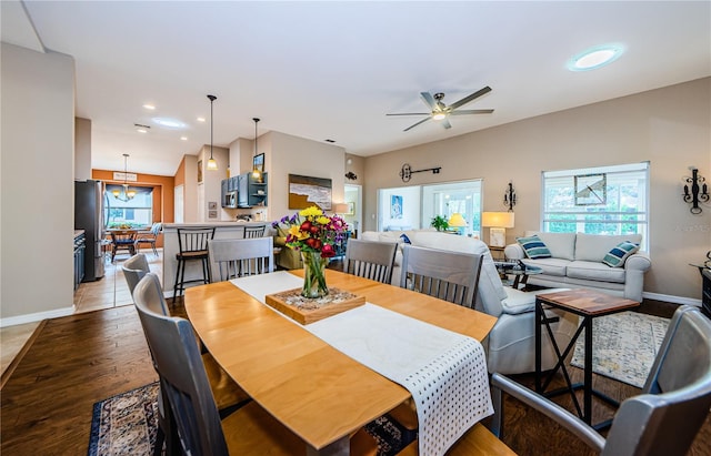 dining room featuring hardwood / wood-style floors, plenty of natural light, lofted ceiling, and ceiling fan