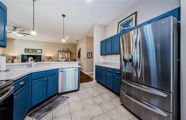 kitchen featuring blue cabinetry, sink, and appliances with stainless steel finishes