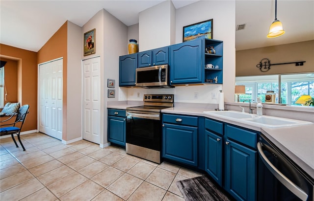 kitchen featuring blue cabinets, pendant lighting, sink, and stainless steel appliances