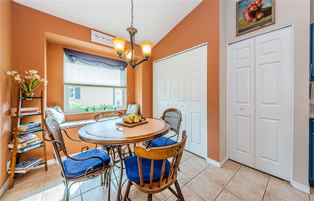 dining room featuring lofted ceiling, a notable chandelier, and light tile patterned flooring