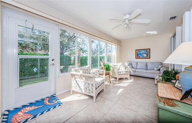 sunroom / solarium featuring a wealth of natural light and ceiling fan