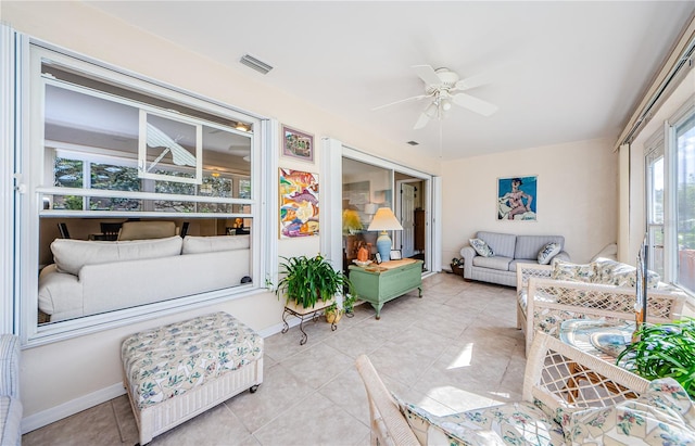 sunroom / solarium featuring ceiling fan