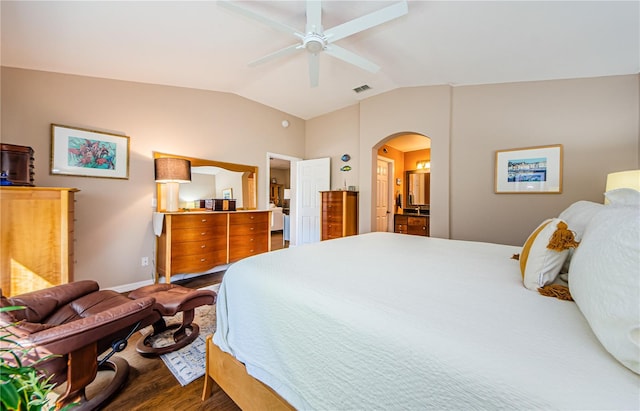 bedroom featuring ensuite bathroom, ceiling fan, lofted ceiling, and hardwood / wood-style flooring