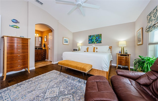 bedroom featuring connected bathroom, dark hardwood / wood-style flooring, vaulted ceiling, and ceiling fan