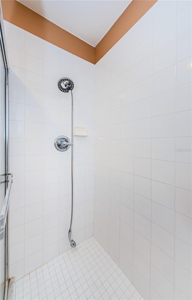 bathroom with tiled shower