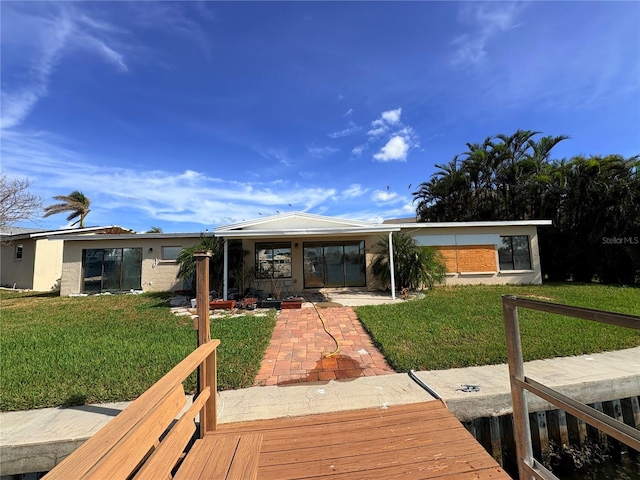 rear view of property with a yard