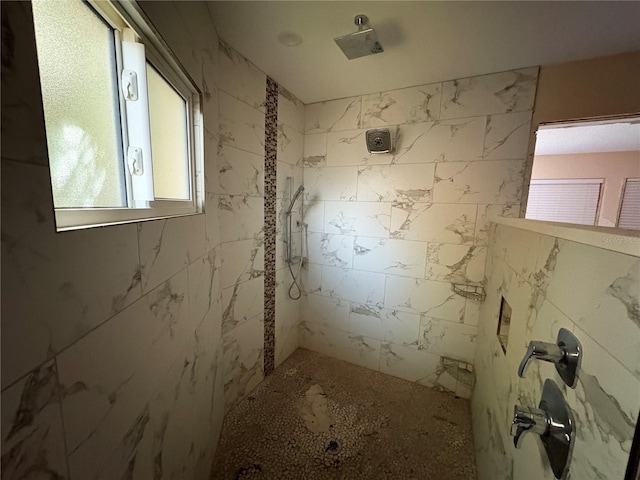 bathroom with a tile shower