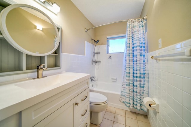 full bathroom with shower / tub combo, vanity, tile walls, tile patterned flooring, and toilet