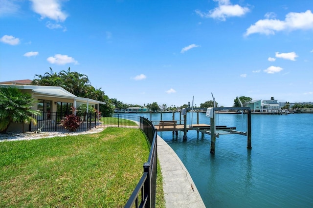 view of dock with a yard and a water view