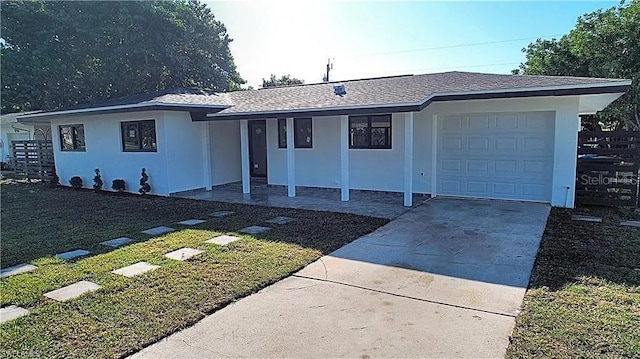 single story home featuring a garage and a front lawn