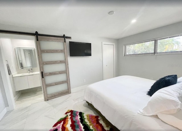 bedroom with ensuite bathroom and a barn door