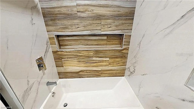 bathroom featuring washtub / shower combination