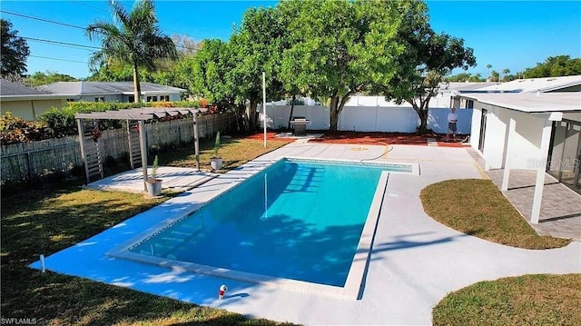 view of swimming pool featuring a yard and a patio area