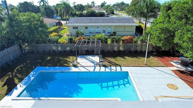 view of swimming pool with a lawn and a patio area