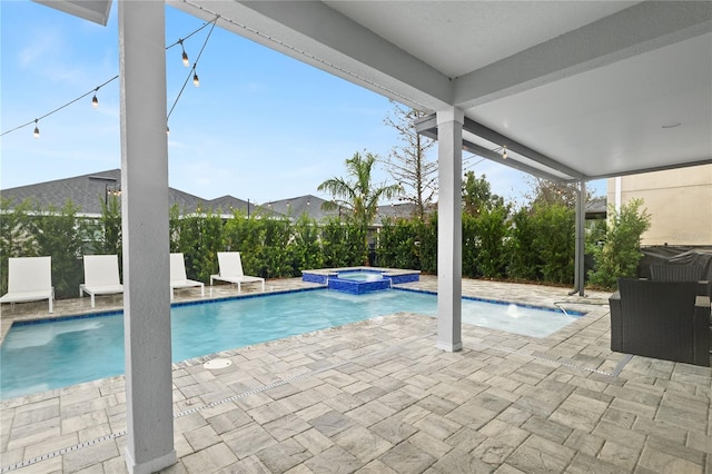 view of swimming pool featuring an in ground hot tub, pool water feature, and a patio