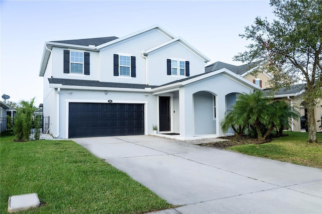 view of front of home with a garage and a front lawn