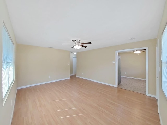 empty room with light hardwood / wood-style flooring and ceiling fan