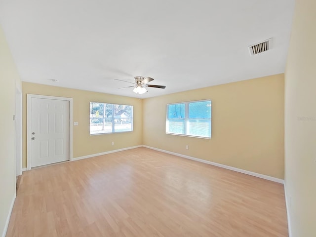 empty room with light hardwood / wood-style flooring and ceiling fan