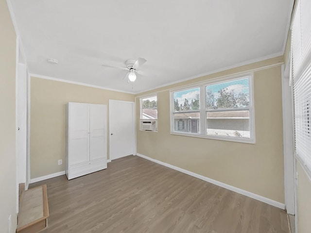 unfurnished bedroom with a closet, ceiling fan, hardwood / wood-style floors, and crown molding