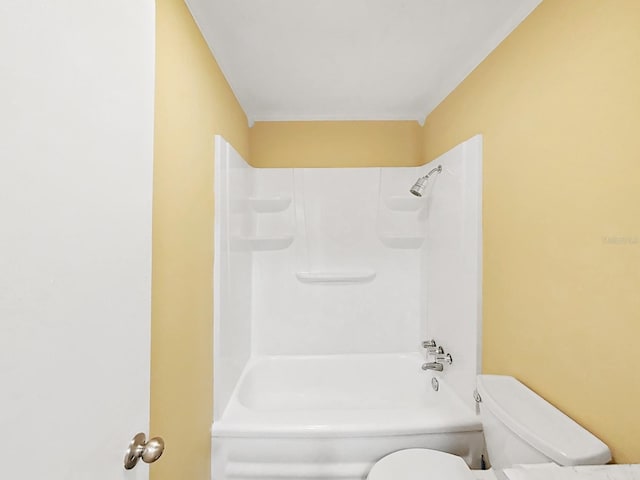 bathroom featuring shower / bathing tub combination and toilet