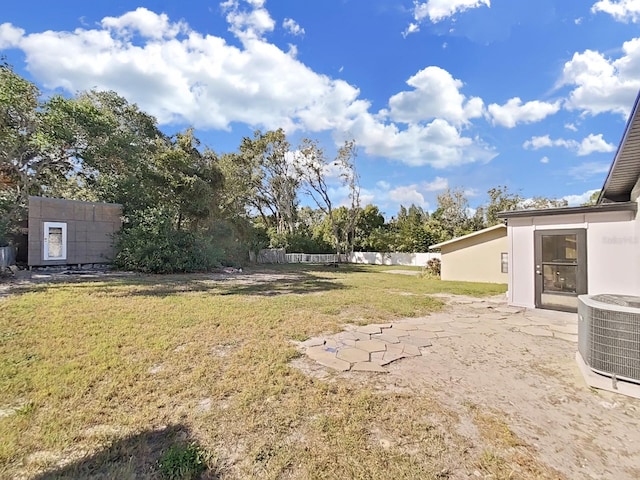 view of yard with cooling unit and a patio area