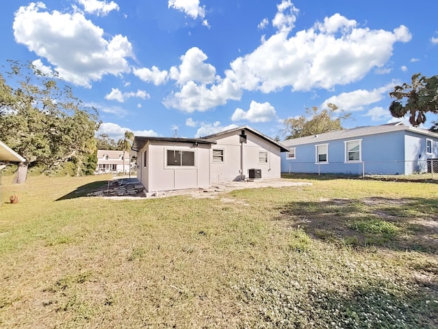 rear view of house with a lawn