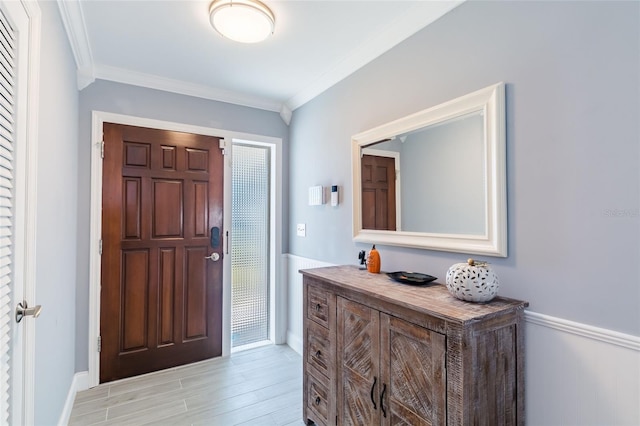 entryway featuring light hardwood / wood-style flooring and ornamental molding