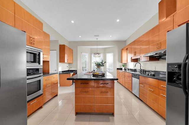 kitchen featuring appliances with stainless steel finishes, sink, pendant lighting, a center island, and light tile patterned flooring