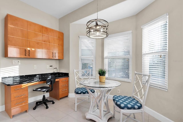 tiled home office featuring a notable chandelier