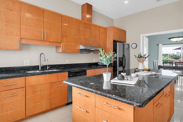 kitchen with a center island, sink, dark stone countertops, light tile patterned floors, and stainless steel appliances