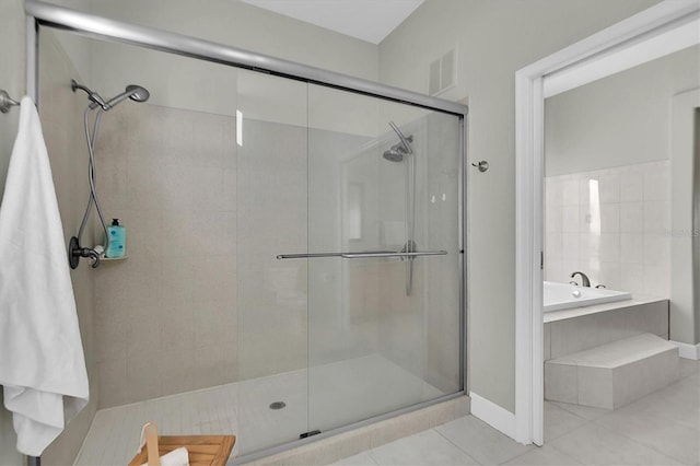 bathroom featuring tile patterned floors and independent shower and bath