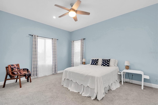 bedroom featuring light carpet and ceiling fan