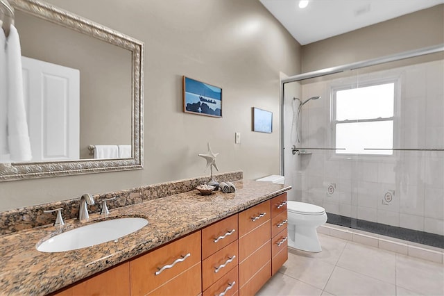 bathroom with toilet, vanity, tile patterned floors, and an enclosed shower