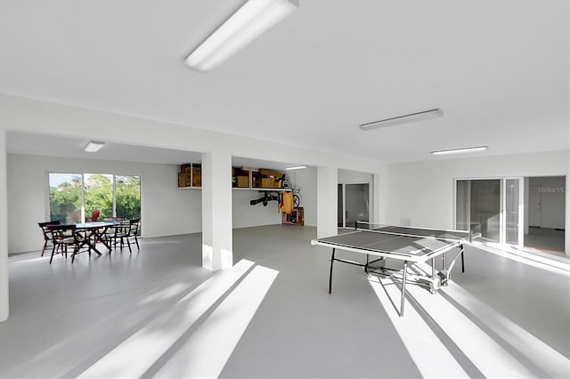 rec room with concrete flooring