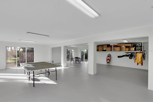 rec room with concrete flooring