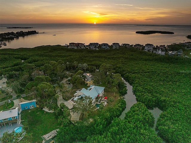 aerial view at dusk with a water view