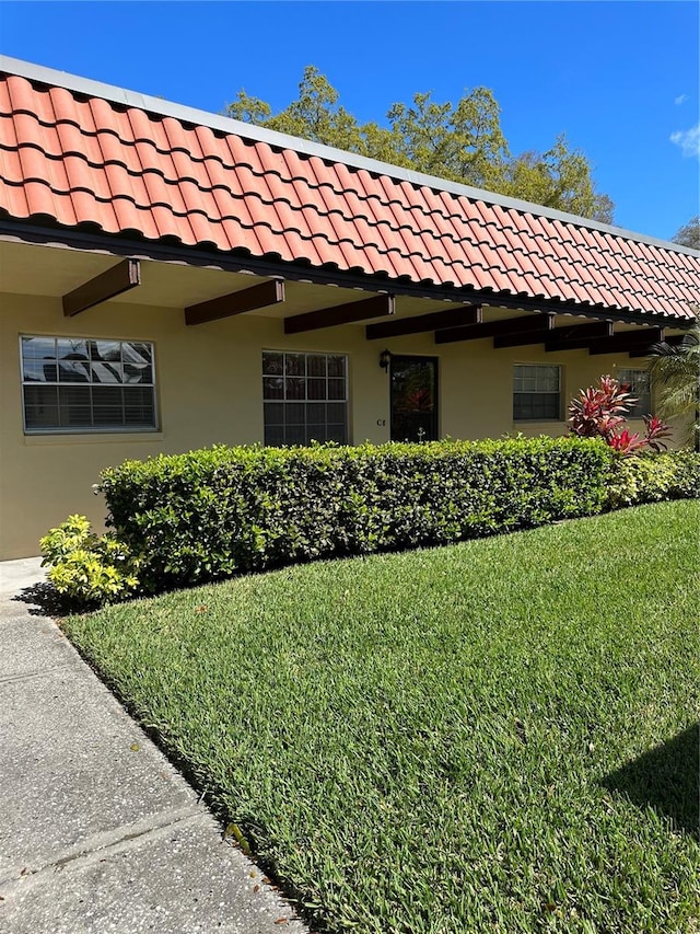 view of side of home featuring a yard