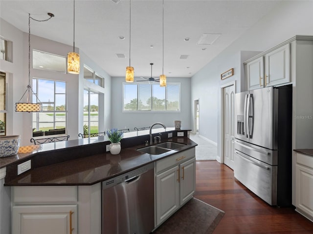 kitchen with stainless steel appliances, hanging light fixtures, plenty of natural light, and sink