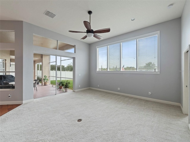 carpeted empty room featuring ceiling fan