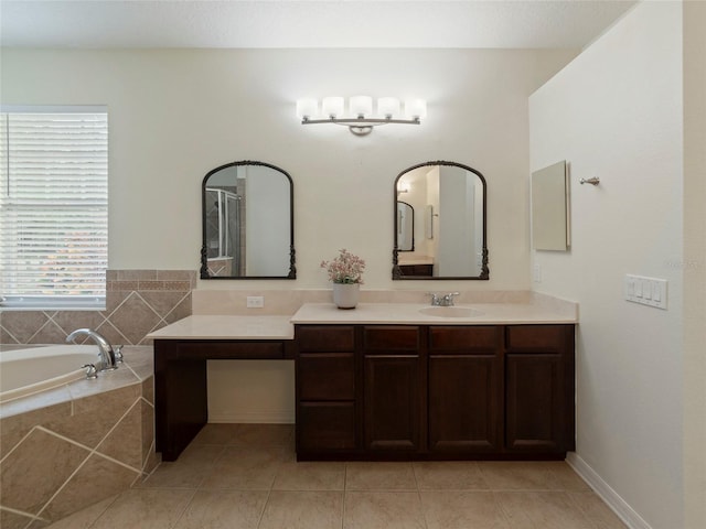 bathroom with vanity, tile patterned flooring, and tiled tub