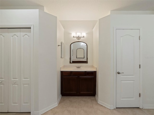 bathroom featuring tile patterned flooring and vanity