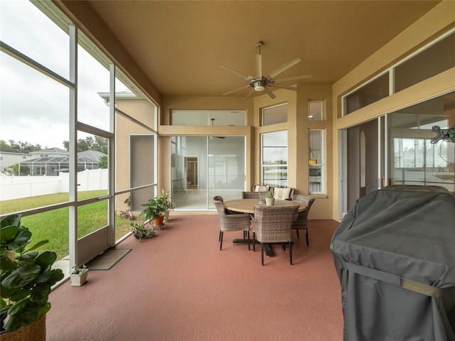 sunroom / solarium featuring ceiling fan