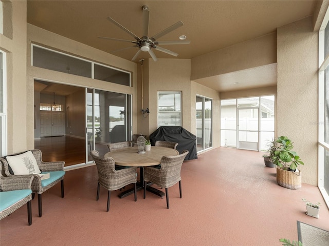 sunroom / solarium featuring ceiling fan