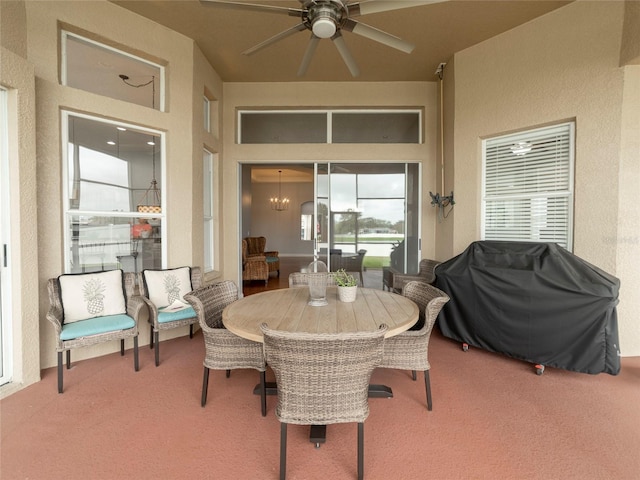 sunroom / solarium with ceiling fan with notable chandelier