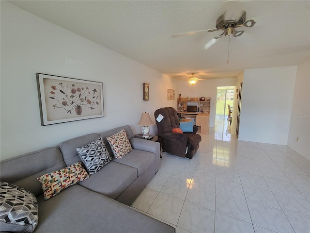 tiled living room featuring a textured ceiling, vaulted ceiling, and ceiling fan