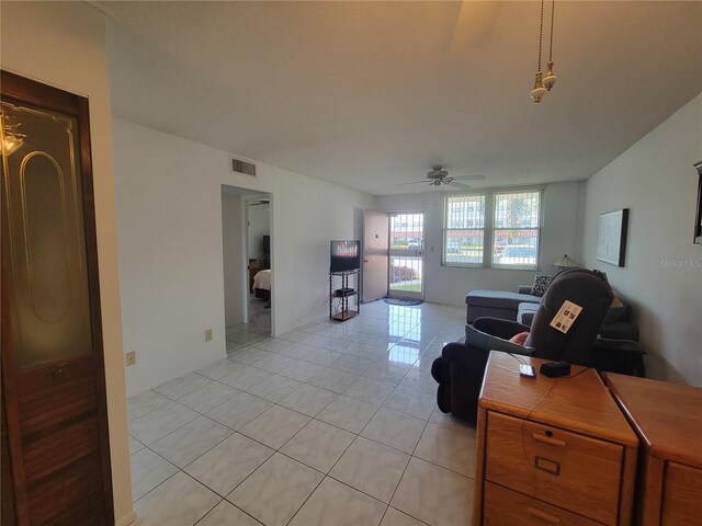 living room featuring light tile patterned floors and ceiling fan