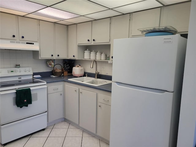 kitchen with light tile patterned flooring, white appliances, sink, and decorative backsplash